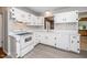 Bright kitchen features white cabinetry, modern appliances, and updated flooring for a fresh, clean look at 202 Crest Rd, Cary, NC 27513