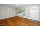 Bright living room with hardwood floors, white trim, and large windows with natural light at 202 Crest Rd, Cary, NC 27513