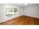 Spacious living room featuring hardwood floors, large windows, and lots of natural light at 202 Crest Rd, Cary, NC 27513