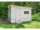 A practical white storage shed sits in a well-maintained yard surrounded by lush greenery at 202 Crest Rd, Cary, NC 27513