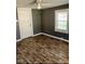 Cozy bedroom featuring hardwood-style floors, natural light from window, and ceiling fan at 207 2Nd St, Erwin, NC 28339