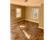 A view of the bedroom featuring hardwood-style floors, windows, and neutral color walls at 207 2Nd St, Erwin, NC 28339