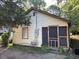 Cozy home featuring a small, enclosed porch entrance and weathered wood siding with a chair outside at 207 2Nd St, Erwin, NC 28339