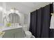 Stylish bathroom features a green vanity, round mirror, and updated fixtures at 216 Burkwood Ln, Raleigh, NC 27609