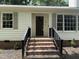 Inviting entryway with brick steps, black railings, and a stylish front door with decorative window panes at 216 Burkwood Ln, Raleigh, NC 27609