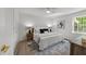 Well-lit bedroom with modern furnishings, ceiling fan, and a large window at 216 Burkwood Ln, Raleigh, NC 27609