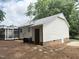 Back exterior featuring a door and an A/C unit, with a screened porch in the background at 216 Burkwood Ln, Raleigh, NC 27609