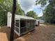 Back of house showing screened in porch with backyard and pine needle ground cover at 216 Burkwood Ln, Raleigh, NC 27609