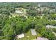 Aerial view of community amenities, including a sparkling pool, tennis courts, and a scenic pond at 2205 Landings Way, Raleigh, NC 27615