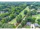 Overhead view of a golf course community with mature trees and winding roads at 2205 Landings Way, Raleigh, NC 27615