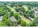 Aerial view of community located on a beautiful golf course with lush landscaping and a pond at 2205 Landings Way, Raleigh, NC 27615