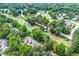 Aerial view of a community situated near a golf course and a picturesque lake at 2205 Landings Way, Raleigh, NC 27615