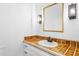 Stylish bathroom featuring tiled countertops, a sink, and modern fixtures at 2205 Landings Way, Raleigh, NC 27615
