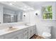 Bathroom featuring a double vanity with neutral counters, updated fixtures, and shower at 2205 Landings Way, Raleigh, NC 27615