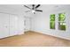 Bright bedroom with a ceiling fan, double door closet, wood floors, and natural light at 2205 Landings Way, Raleigh, NC 27615