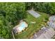 Aerial view of the community pool and tennis courts surrounded by beautiful landscaping and trees at 2205 Landings Way, Raleigh, NC 27615