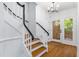Bright foyer featuring hardwood floors, a modern chandelier, and access to the entryway at 2205 Landings Way, Raleigh, NC 27615