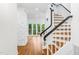 Bright entryway with hardwood floors, staircase, and an accent wall with a stone facade at 2205 Landings Way, Raleigh, NC 27615
