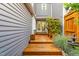 View of the wooden deck entryway with a decorative trellis and access to the home's entrance at 2205 Landings Way, Raleigh, NC 27615