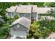 Two-story home boasts an attached two-car garage, neat landscaping, and is surrounded by mature trees at 2205 Landings Way, Raleigh, NC 27615