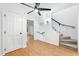 Hallway featuring hardwood floors, a ceiling fan, a staircase, and an interior door at 2205 Landings Way, Raleigh, NC 27615