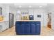 Bright kitchen features a blue island, stainless steel appliances and ample counter space at 2205 Landings Way, Raleigh, NC 27615