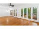 Bright living room featuring hardwood floors and large windows with natural light at 2205 Landings Way, Raleigh, NC 27615