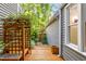 Tranquil sideyard with wooden deck, decorative trellis, and lush greenery, offering a serene outdoor space at 2205 Landings Way, Raleigh, NC 27615