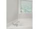 Bright bathroom featuring a large soaking tub under a window with lots of natural light at 222 Ashton Hall Ln, Raleigh, NC 27609