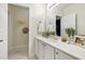 Bright bathroom featuring double sinks with white countertop, and decorative fixtures at 222 Ashton Hall Ln, Raleigh, NC 27609