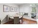 Cozy dining area with wood floors, natural light, and seating for four at 222 Ashton Hall Ln, Raleigh, NC 27609