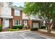 Charming townhome featuring brick facade, one car garage, and meticulously manicured landscaping at 222 Ashton Hall Ln, Raleigh, NC 27609