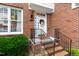 Close-up of the welcoming front door, complete with wreath and brick steps with iron railing at 222 Ashton Hall Ln, Raleigh, NC 27609