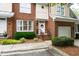 Inviting townhouse showcases a brick facade, manicured landscaping, and cozy front entrance at 222 Ashton Hall Ln, Raleigh, NC 27609