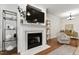 Inviting living room features a fireplace and stylish decor elements and shelving at 222 Ashton Hall Ln, Raleigh, NC 27609