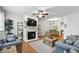 Bright living room with fireplace, neutral color palette, and hardwood flooring at 222 Ashton Hall Ln, Raleigh, NC 27609