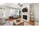 Bright living area boasts hardwood floors, a cozy fireplace, and large sunlit windows at 222 Ashton Hall Ln, Raleigh, NC 27609