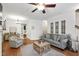 Comfortable living room boasts hardwood flooring, light-filled windows, and stylish furnishings at 222 Ashton Hall Ln, Raleigh, NC 27609