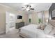 Bedroom featuring a ceiling fan, dresser, and view into the ensuite bathroom at 222 Ashton Hall Ln, Raleigh, NC 27609