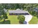 Aerial view of brick home with lush green lawn, driveway, and carport at 3009 Wellington Dr, Rocky Mount, NC 27803