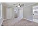 Cozy bedroom with neutral carpet, ceiling fan, and closet access at 3009 Wellington Dr, Rocky Mount, NC 27803