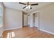 Neutral bedroom boasts hardwood floors, ceiling fan, and closet space at 3009 Wellington Dr, Rocky Mount, NC 27803
