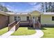 Accessible front entrance with ramp and porch, set against a blue sky at 3009 Wellington Dr, Rocky Mount, NC 27803