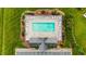 Aerial view of community pool with lounge chairs and tables offering a relaxing and social outdoor space for residents at 305 Slate Dr, Gibsonville, NC 27249