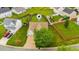 An aerial shot of the home with a well-kept lawn and mature trees in a suburban setting at 305 Slate Dr, Gibsonville, NC 27249
