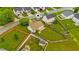 Aerial view of a single-Gathering home showing the large, green backyard with play equipment at 305 Slate Dr, Gibsonville, NC 27249