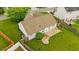 Aerial view showcasing the home's backyard, patio, and landscaped yard at 305 Slate Dr, Gibsonville, NC 27249