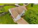 An aerial view of the home showcasing a well-manicured lawn, driveway, and mature trees at 305 Slate Dr, Gibsonville, NC 27249