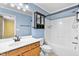 Updated bathroom with wood vanity and shower/tub combo at 305 Slate Dr, Gibsonville, NC 27249