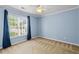Bedroom features neutral carpet, ceiling fan, and blue walls at 305 Slate Dr, Gibsonville, NC 27249